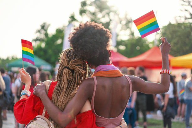 istock Interracial female couple at the pride parade 1173278094