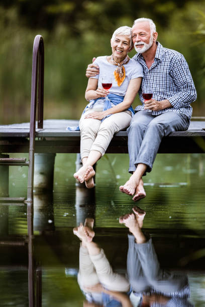 istock Happy embraced senior couple relaxing on a pier. 1173278863