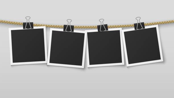 istock Photo frame hanging on rope. Blank photo paper frames, retro picture exhibition and clothespins. Vector album 1173279634