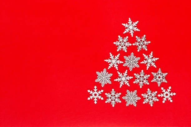 istock White snow flake decoration on red background. Flat lay, top view 1173280807