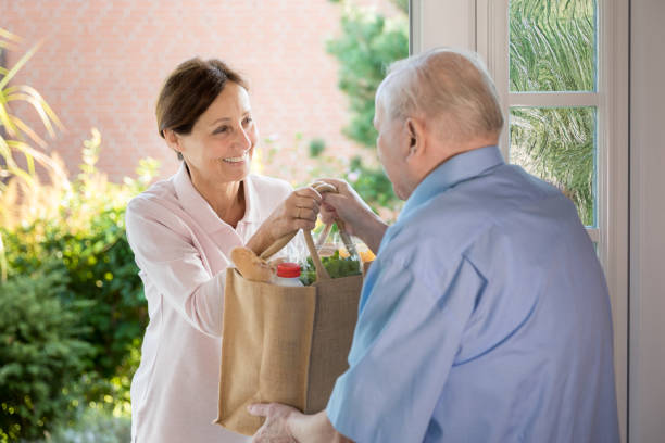 istock Home caregiver – woman helping senior man 1173281477