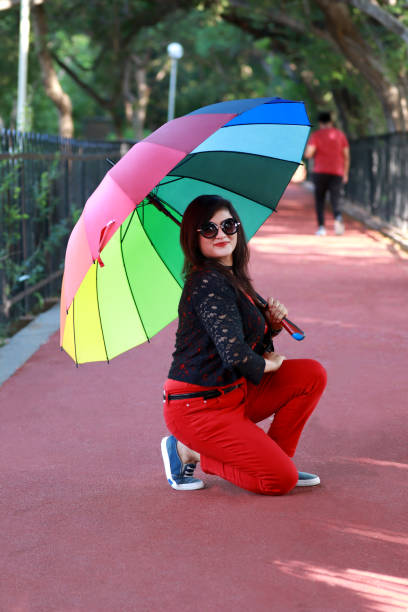 istock Young women under colorful umbrella 1173282290