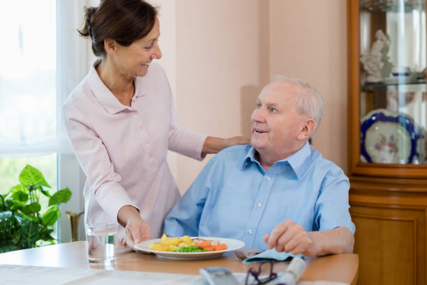 istock Home caregiver – woman helping senior man 1173282985