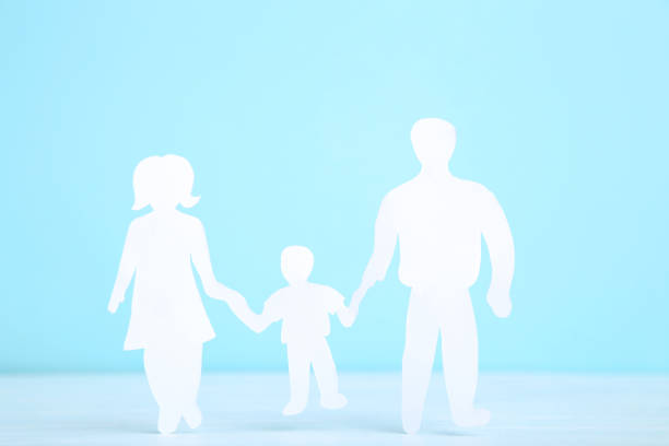 istock Paper family figures on blue background 1173284552