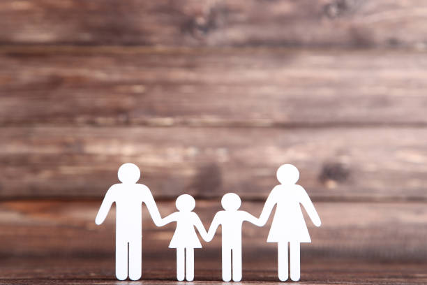 istock Family figures on brown wooden background 1173284609
