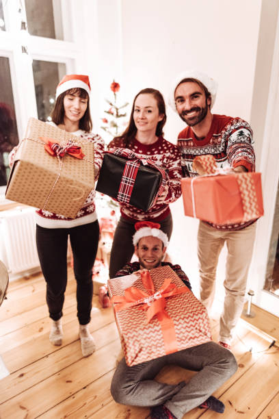 istock friends giving present for christmas 1173285145