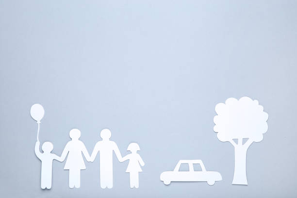 istock Paper family figures with tree and car on gray background 1173286030