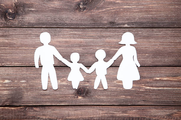 istock Family figures on brown wooden table 1173286063