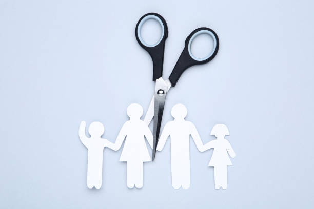 istock Family figures with scissors on gray background 1173286218