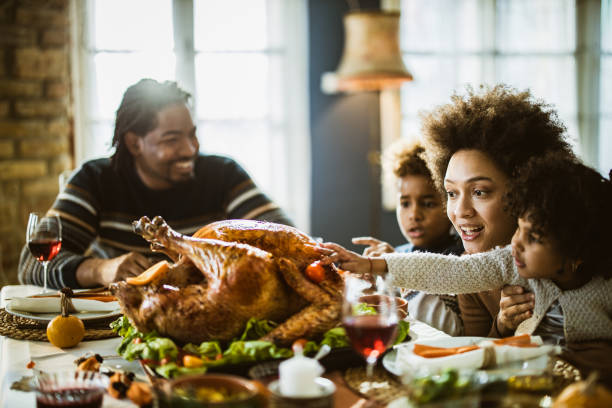istock Happy black family having Thanksgiving meal at dining table. 1173287208