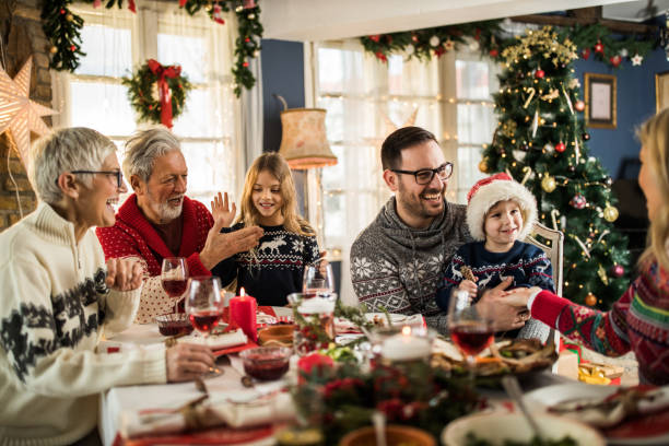 istock Happy extended family talking during New Year's meal at dining table. 1173289737