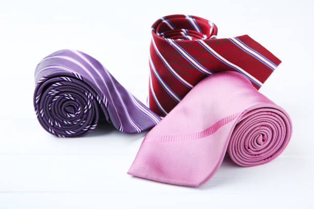 istock Colored neckties on white wooden table 1173290813