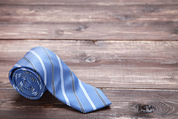istock Striped necktie on brown wooden table 1173290849