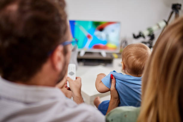 istock Young parents watching TV with baby boy. 1173291032