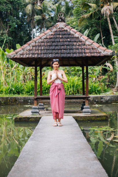 istock Woman Praying at temple in Bali 1173291383