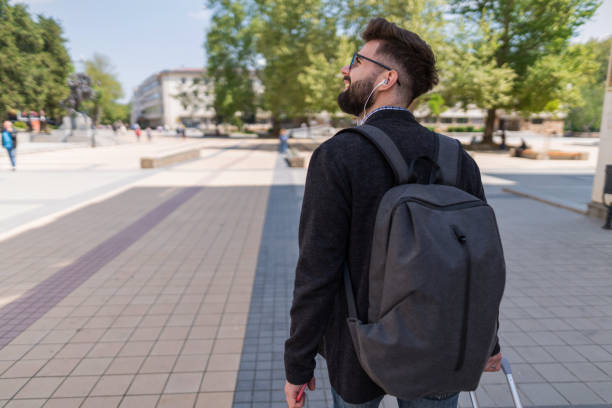 istock Young man walking in the city 1173293246