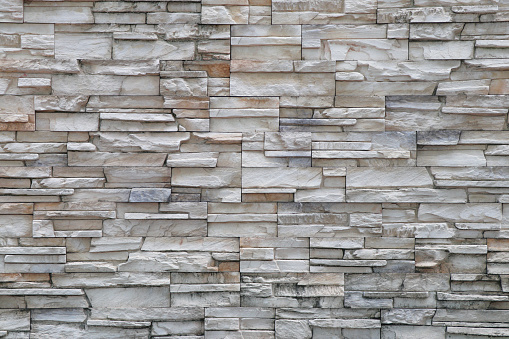 Stone background walls are stacked. Stone cladding background and wallpaper.