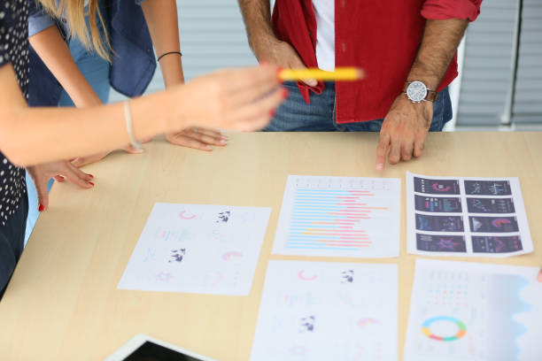 istock Midsection Of Business People Working On Table 1173296014