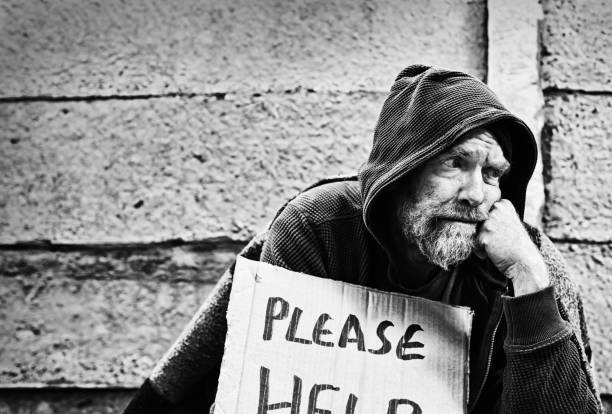 istock Desperate homeless man begging. Black and white image. 1173300388