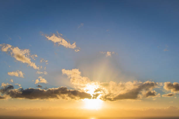 istock Sun setting over a golden blue sunset over the ocean. 1173301301