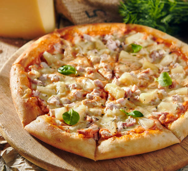istock Pizza Restaurant Menu - Delicious Fresh Pizza with Chicken and Pineapple. Pizza on Rustic Wooden Table with Ingredients 1173302773