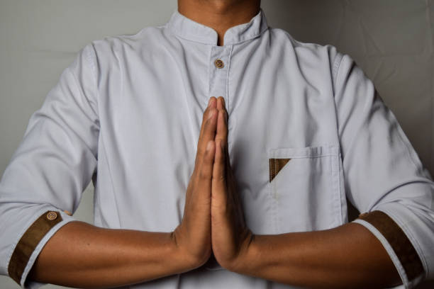 istock Close up Asian man shows hand gestures it means Prayer isolated on white background 1173306374