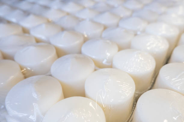 istock Several rows of white wax candles in a store in transparent packaging, top view, diagonal 1173310880
