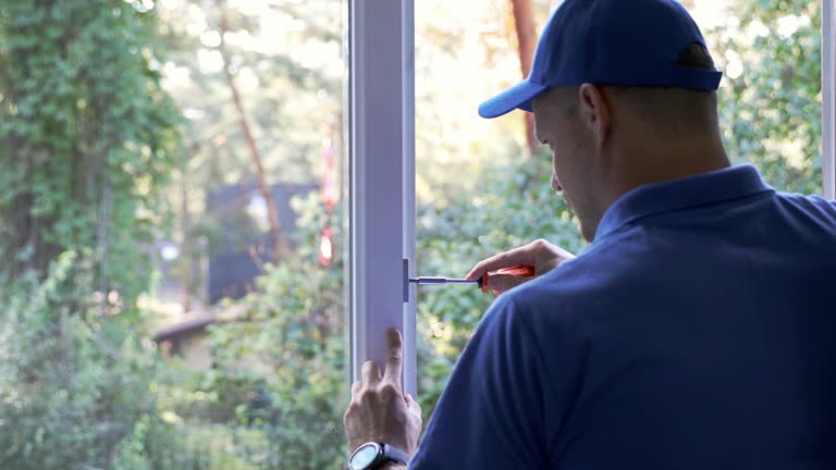 worker repairing and adjusting plastic pvc window