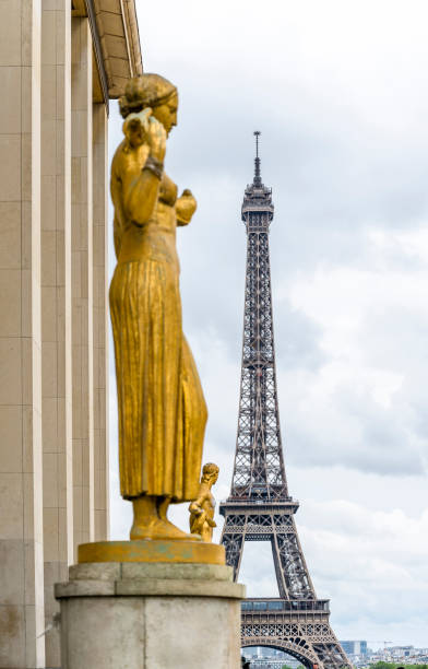 istock Eiffel Tower on the background of bronze sculptures 1173321040