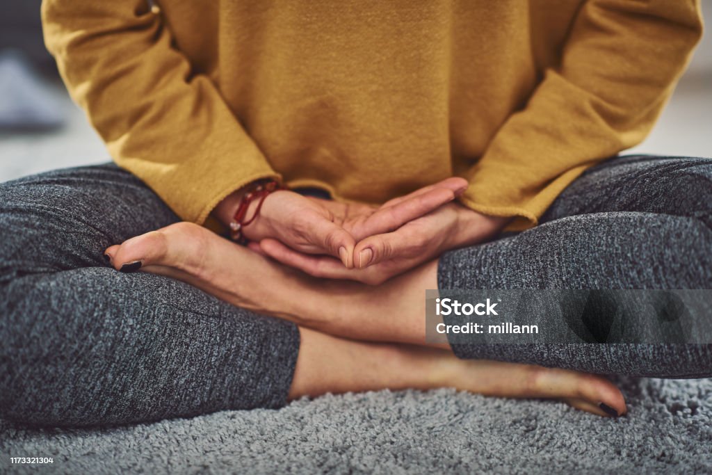 Close up of caucasian woman meditating indoors. Meditating Stock Photo