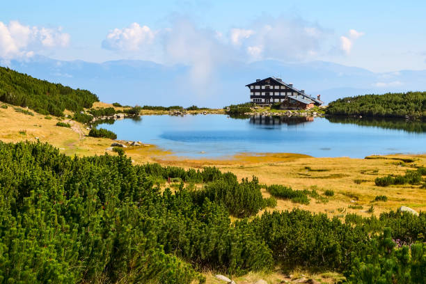 Mountain summer landscape with blue lake and hut hizha house, Bezbog, Bulgaria near Bansko