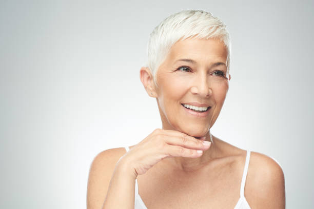 istock Senior woman posing in front of gray background. 1173322372