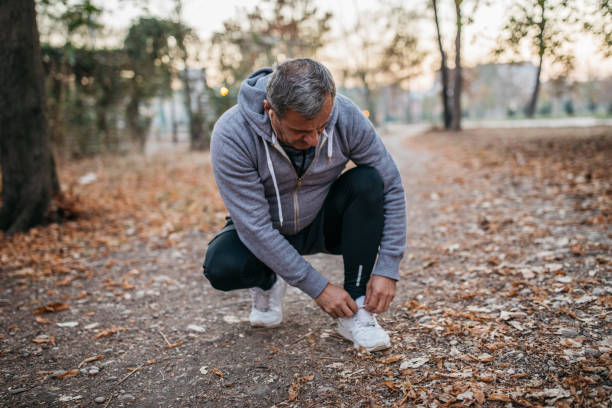 istock An elderly man jogs in a public park 1173323180