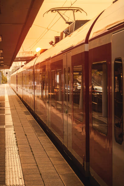 istock Passengers train in station at golden hour 1173323765