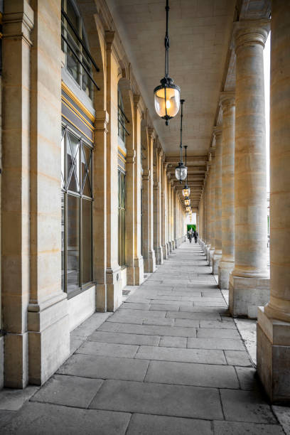 istock Man and woman walk through portico with columns 1173324712