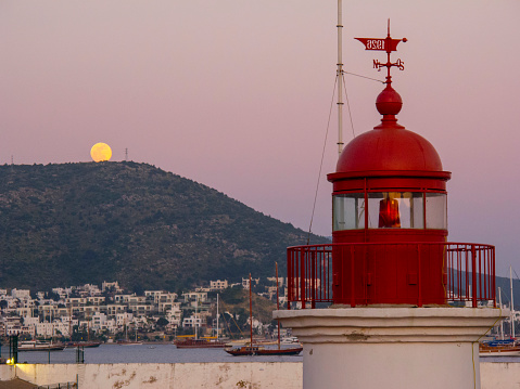 Lighthouse against fullmoon in Bodrum harbor