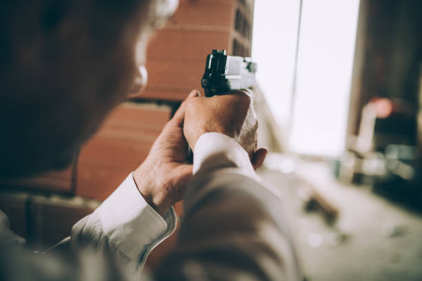 istock An elderly detective in action with a gun 1173327756