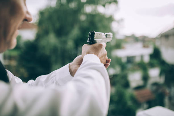 istock An elderly detective in action with a gun 1173327897