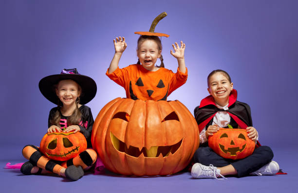 istock little witch, Dracula and pumpkin on purple background 1173328461