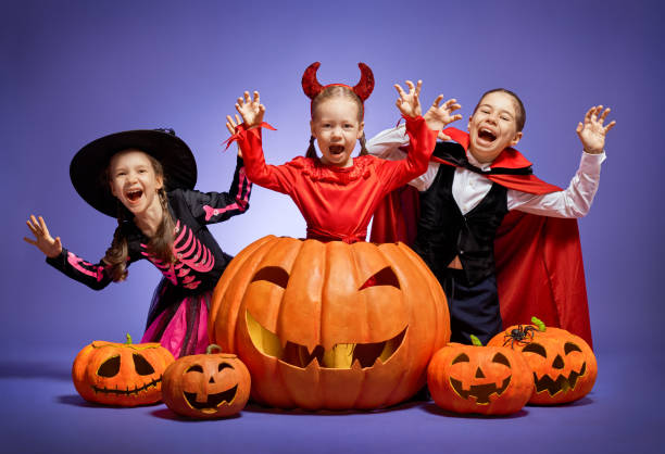 little witch, Dracula and pumpkin on purple background