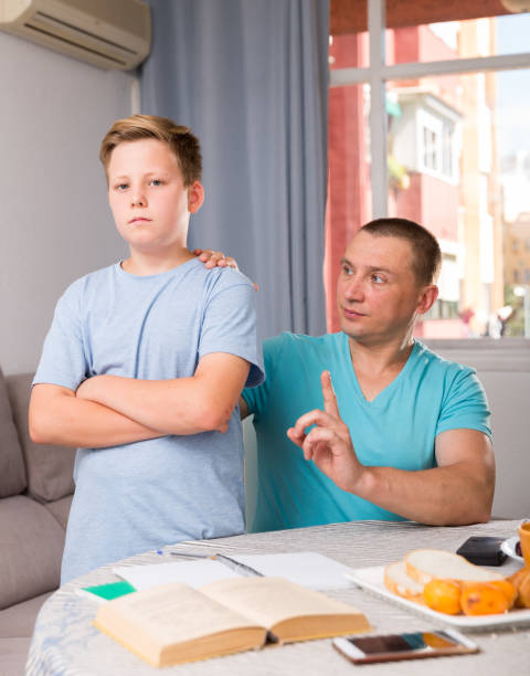 istock Adult son is not wanting talk with his father in time doing homework 1173329530