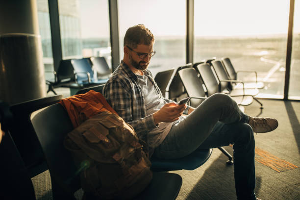 istock Guy sitting alone in waiting room on airport 1173332285
