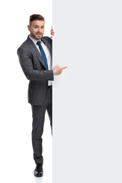 istock young businessman pointing finger at a big blank board 1173332319