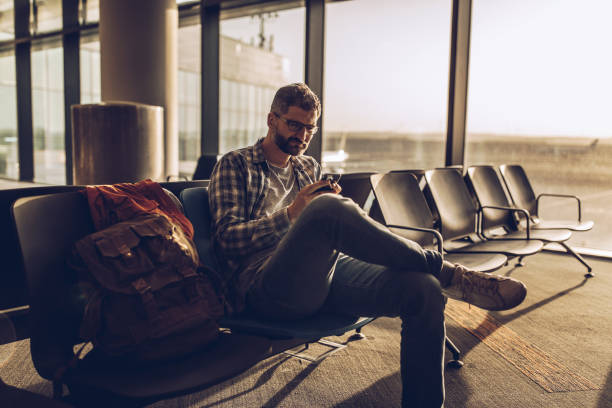 istock Man sitting in waiting room on airport 1173332321