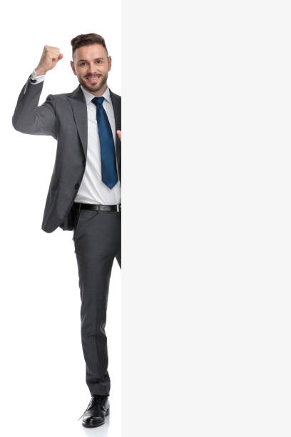 istock businessman celebrates success while presenting big blank billboard 1173332344