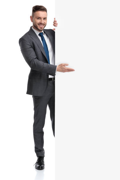 istock businessman standing behind big billboard and shows the message 1173332693