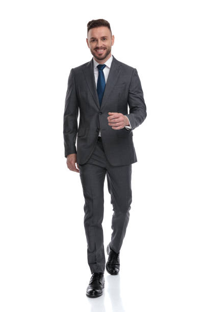 istock confident young businessman wearing suit and tie is walking forward 1173332995