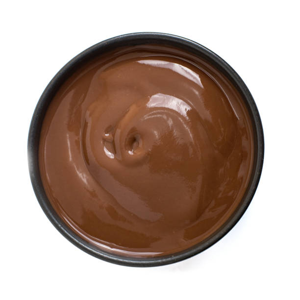 istock Chocolate pudding in dark bowl isolated on white background. Top view 1173333942