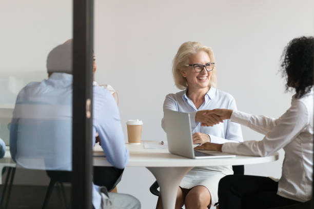 istock Smiling diverse female colleagues handshake greeting at meeting 1173335893