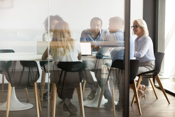 istock Multiethnic employee brainstorm discuss ideas together in boardroom 1173335897